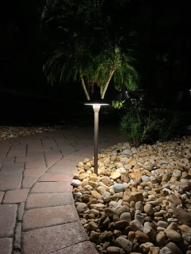 LED safety walkway lighting along a stone pathway with plants in Windermere, Central Florida