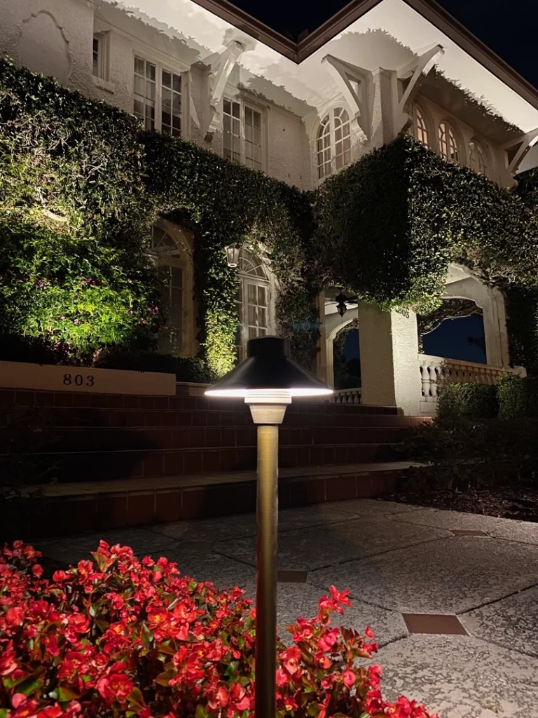 LED safety walkway lighting in College Park, Central Florida, illuminating a pathway near a landscaped entrance
