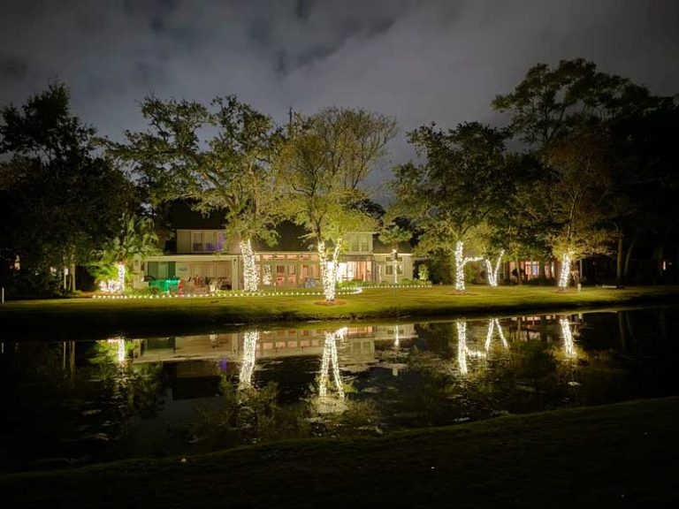 Exterior view of Florida home on water with Holiday Christmas lights installed professionally by Southern Outdoor Lighting