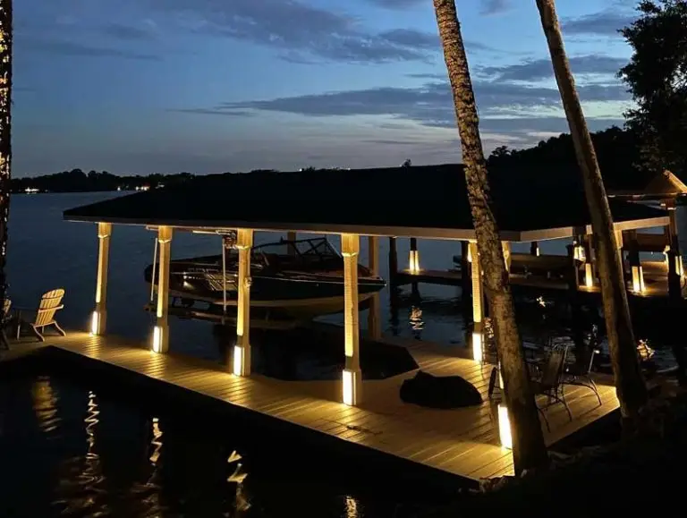 Beautifully lit night shot of a boat dock. The lighting designed and installed by Southern Outdoor Lighting