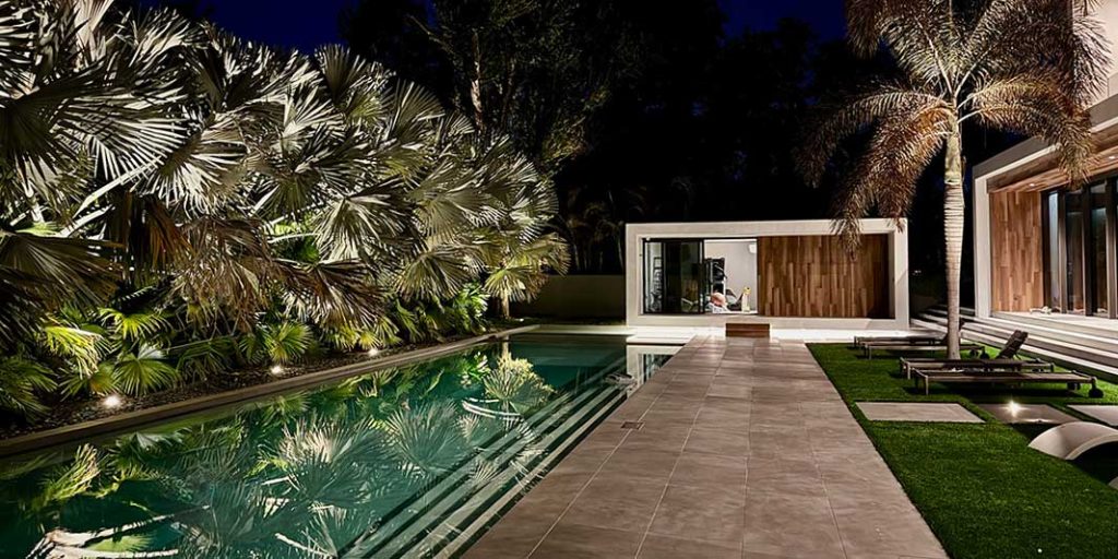 A luxury backyard lighting designed by Souther Lighting Outdoor featuring recessed and hidden lights.