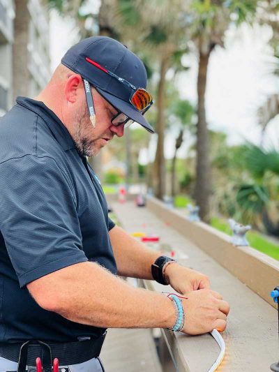 Owner, Jaison Heard, performing maintenance work on an outdoor led landcape lighting installation